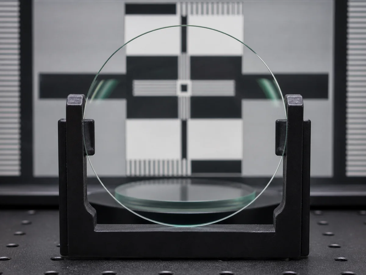 Clear CR-39 optical lenses displayed for material and coating inspection